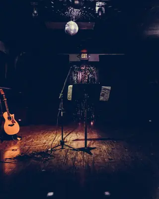 A small stage with a guitar and a microphone